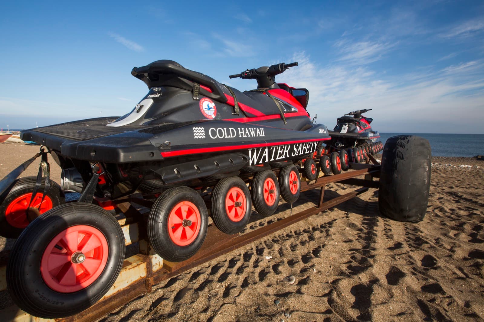Jet skis strapped on a trailer, ready for delivery